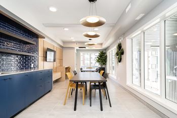a long dining room with a long table and chairs and large windows